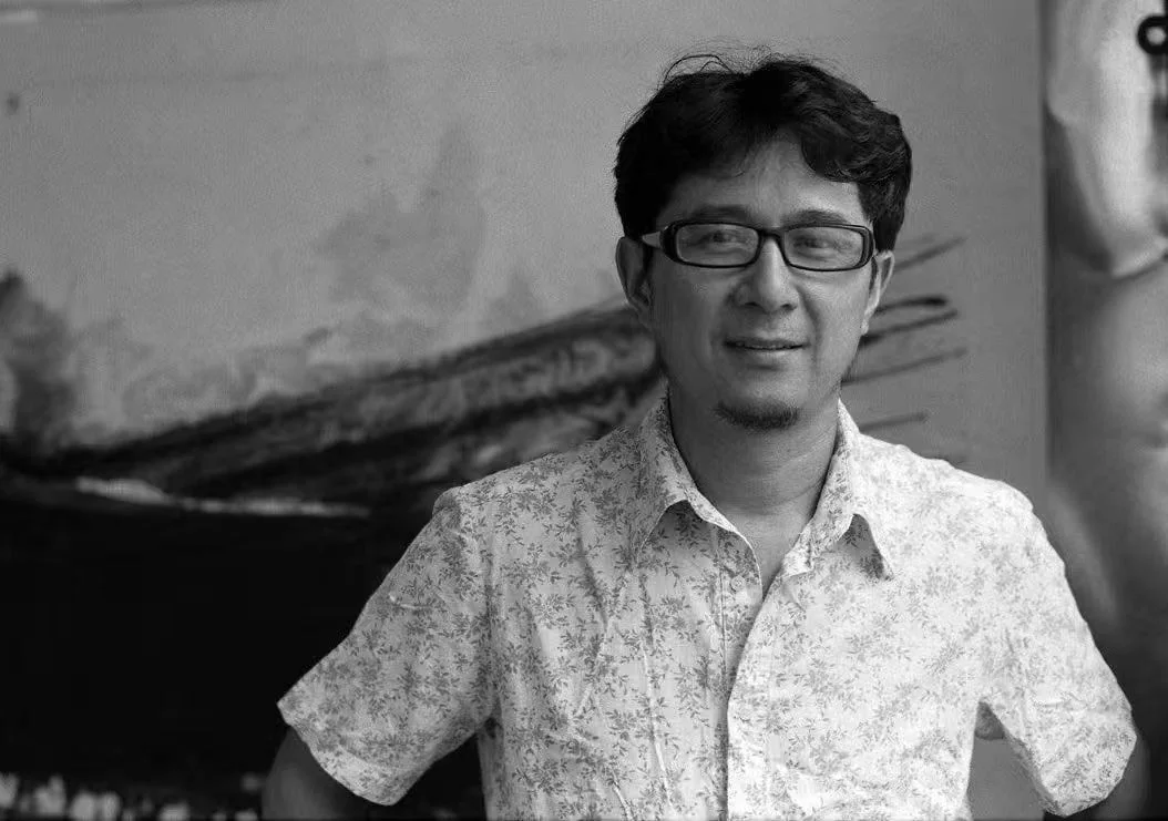 艺术家在水墨作品前的黑白肖像